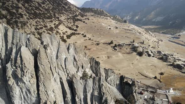 Flying over rocking hill looking down at Bhraka Village alt
