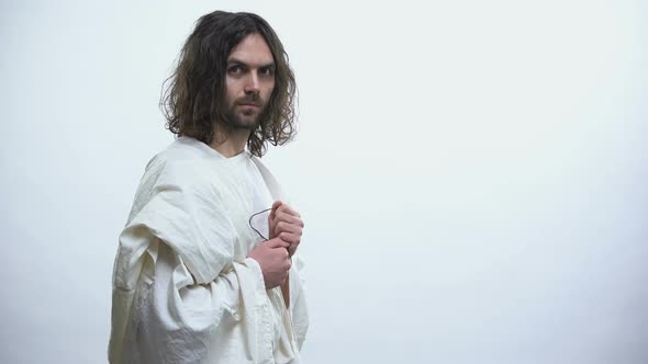 Prophet in White Robe Holding Out Cross to Camera, Religious Conversion, Baptism alt