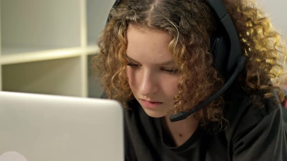 Teenage Girl Using Laptop and Wearing Headphones