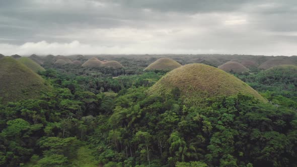 Chocolate Hills Aerial View Mountains with High Trees and Rain Clouds on Spring Day Natural Wonder