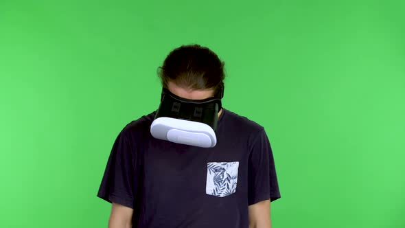Portrait of a Young Man with a Virtual Reality Headset or 3d Glasses on His Head alt