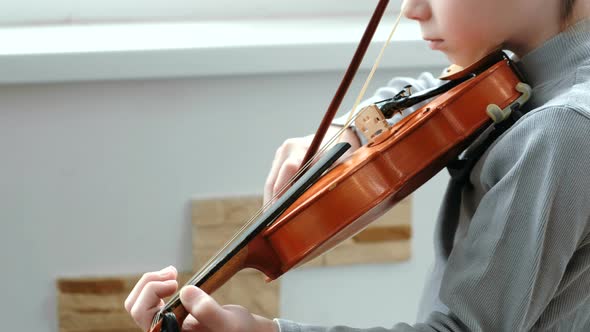 Playing the Violin. Unrecognizable Seven Years Old Boy Playing the Violin