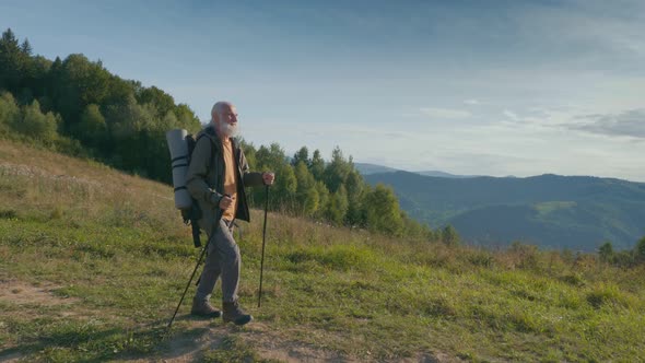 The Traveler Makes a Hike in the Mountains Enjoys Nature alt