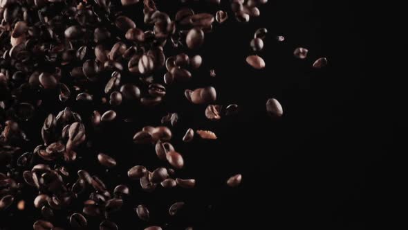 Levitation of Coffee Beans From Bottom to Top on a Black Background