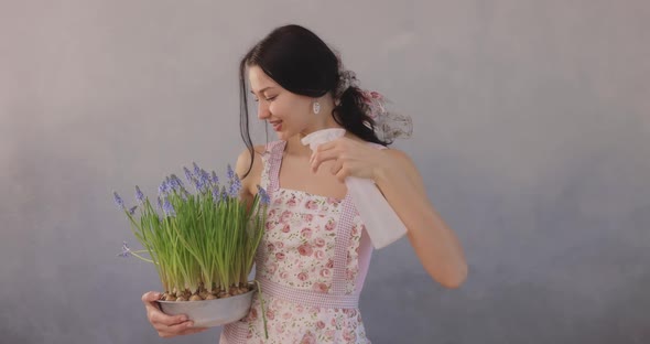 Woman Holding Bouquet of Flowers in Hands Indoors alt