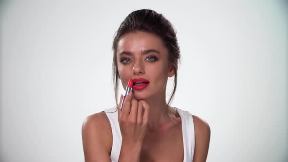 Beauty Lips Makeup. Sexy Woman Applying Red Lipstick On Full Lip alt