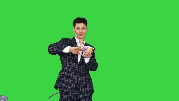Man in Formal Suit Throwing Money in the Air on a Green Screen, Chroma Key. alt