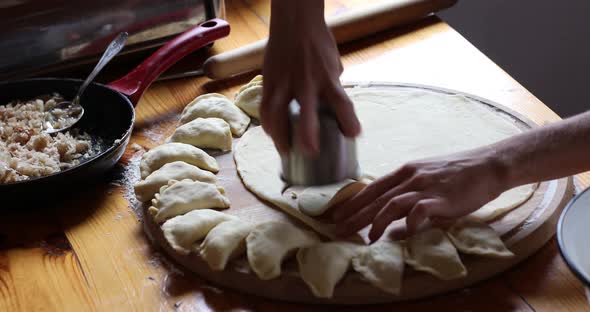 The raw traditional Ukrainian hand-made vareniki (dumpling) with cabbage inside alt
