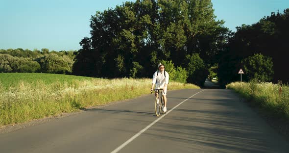 Man Riding Bicycle in Countryside