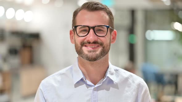 Portrait of Positive Businessman Saying Yes By Shaking Head alt