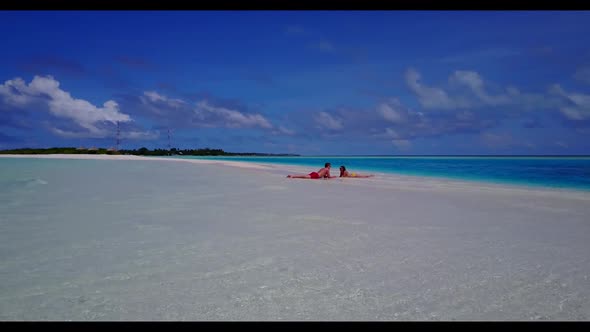 Teenage lovers posing on tropical shore beach voyage by clear ocean and white sandy background of th alt