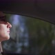 Young Woman Taxi Driver with Glasses Riding at Sunset Side View - VideoHive Item for Sale
