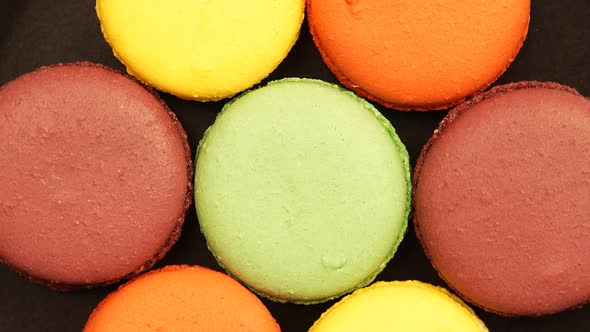 ROTATION: Top view of a Colorful Macaroons on a black table