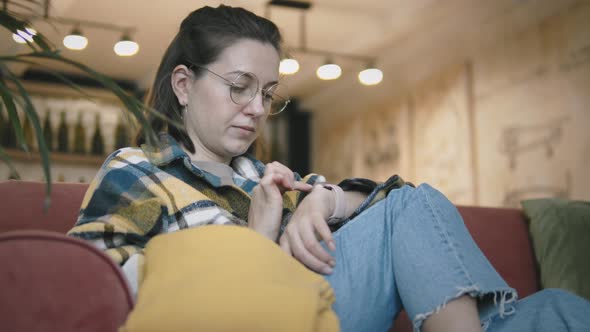 Young Woman Using Smartwatch alt
