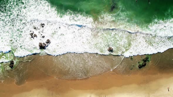 Tropical Sea Waves Hitting Sandy Beach with Sun Reflection, Aerial Top Down View alt