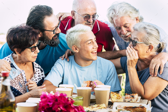 Group of mixed generations ages of people have fun together during pizza lunch - Stock Photo - Images