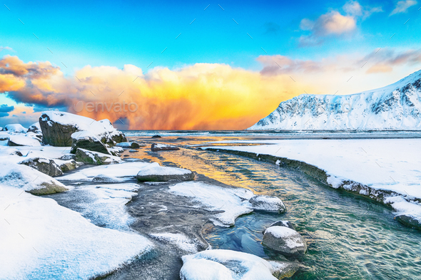 Fabulous winter scenery on Skagsanden beach with illuminated clouds during sunrise. - Stock Photo - Images