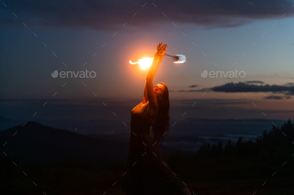 Graceful elegant red haired female fireshow performer - Stock Photo - Images