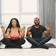 Handsome Afro American couple doing yoga at home - PhotoDune Item for Sale