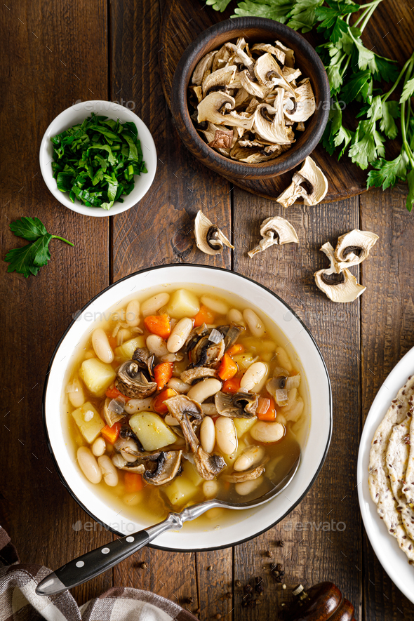 Mushroom soup with kidney bean, potato and carrot. Top view Stock Photo