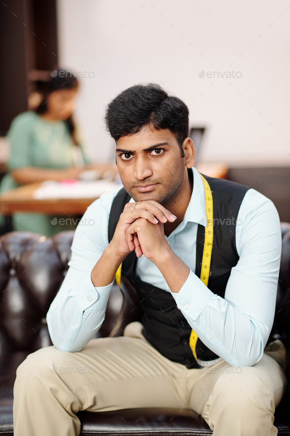 Young serious Indian tailor