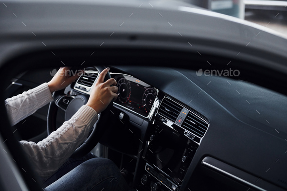 Particle view of man in formal wear that riding brand new car