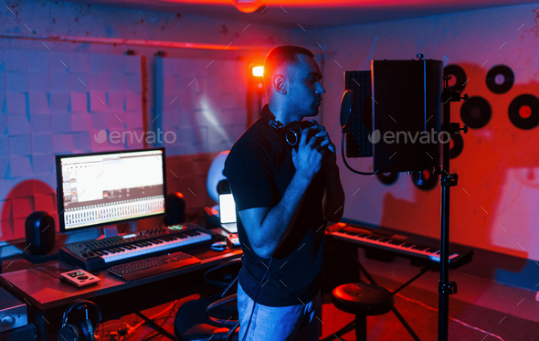 Vocalist have recording session indoors in the modern professional studio