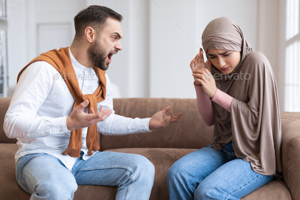 Aggressive Muslim Husband Shouting At Scared Wife Sitting At Home