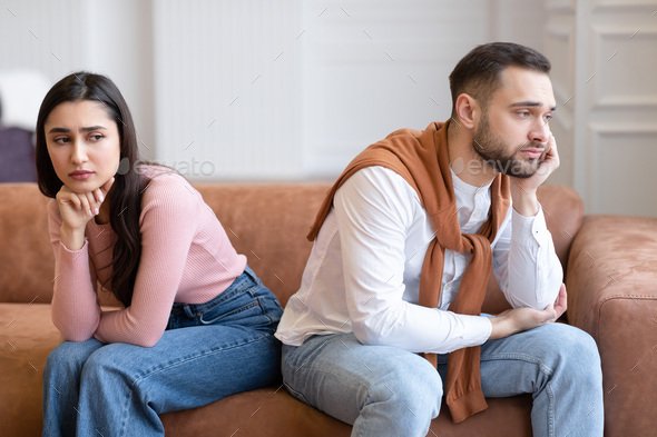 Unhappy Arab Couple Sitting Back-To-Back Not Talking After Quarrel Indoor