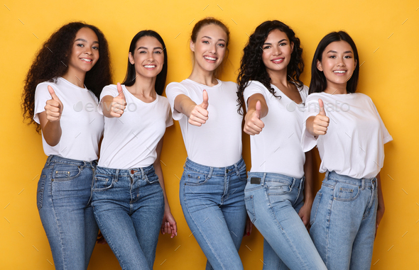 Five Females Models Gesturing Thumbs-Up Approving Something Over Yellow ...