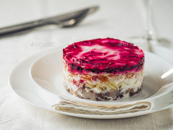 Salad herring under fur coat on festive plate - Stock Photo - Images
