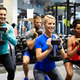 Group of sportive people in gym. Happy fit friends workout, exercise in  fitness club Stock Photo by nd3000
