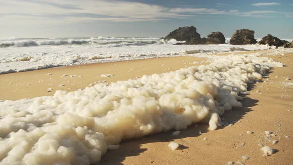 Sea Foam (aka Beach Foam, Ocean Foam or Spume) on a Sandy Beach on the Atlantic Coast of Portugal at alt
