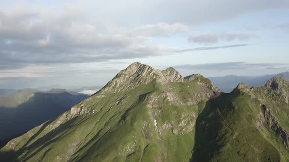 Natural Mountain Peak Cliff Terrain at Sun Light Surrounded Cloudy Blue Sky Organic Landscape alt
