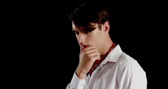 Androgynous man posing against black background alt