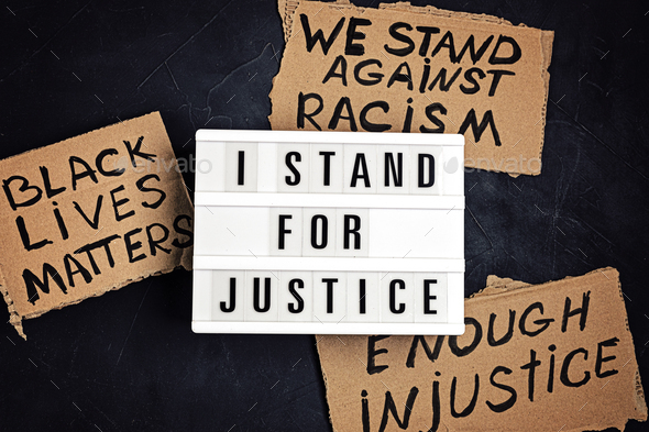 I stand for justice text on light box and other anti racism slogans
