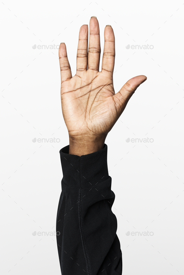 Hand showing palm gesture with black long sleeve