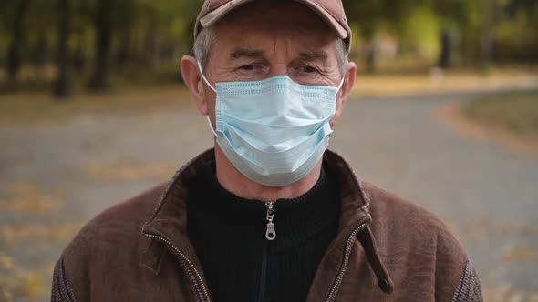 Close Up Portrait of Senior Man Wearing Protective Medical Face Mask