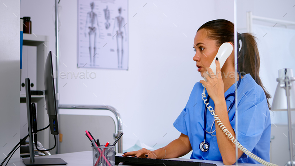 Specialist healthcare physician talking at phone in medicine clinic
