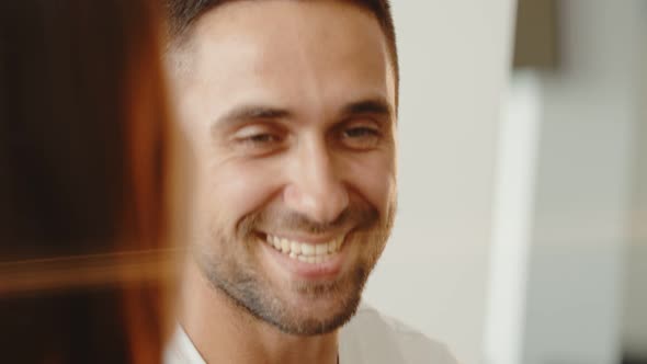 Smiling Bearded Millennial Professional Businessman Talking with His Colleague alt