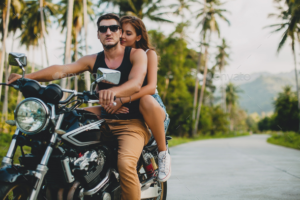 young couple in love, riding a motorcycle, hug, passion, free spirit