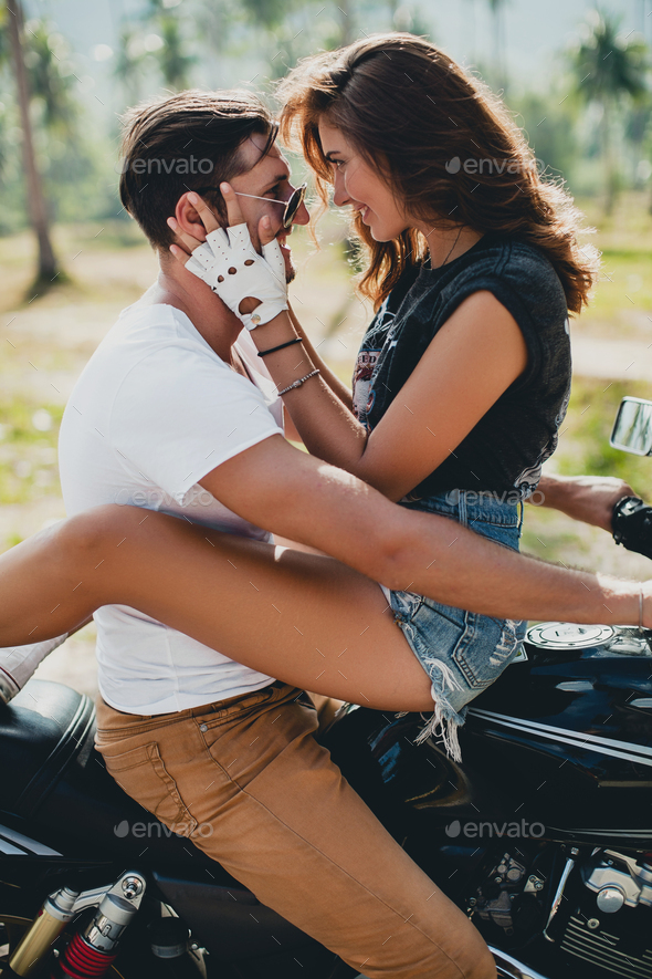 young couple in love, riding a motorcycle, hug, passion, free spirit