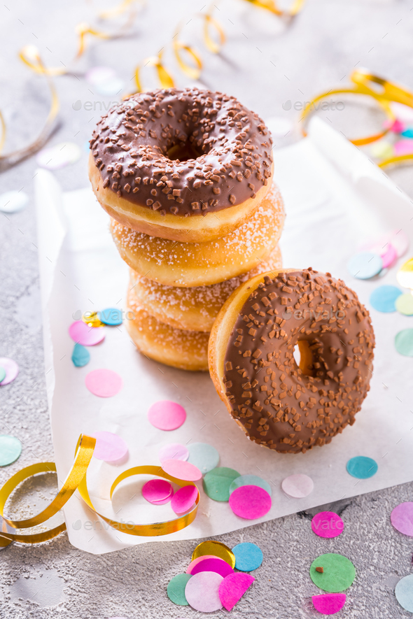 Donuts with streamers and confetti. Donuts for carnival and party