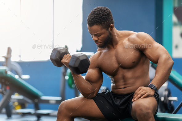 handsome bi-racial man workout with barbell in home gym Stock