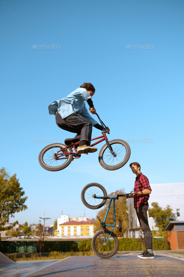 Bmx biker, jump in action, training in skatepark
