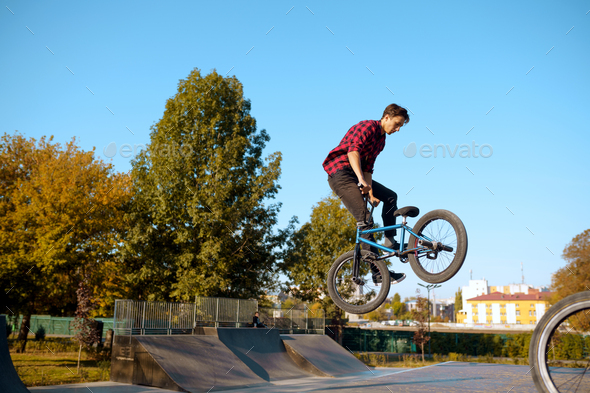 Bmx biker, jump in action, training in skatepark