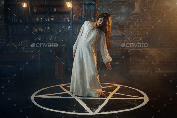 Creepy demonic woman standing in the magic circle