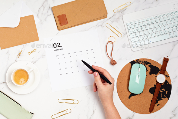 Desktop with calendar for february and office supplies - Stock Photo - Images