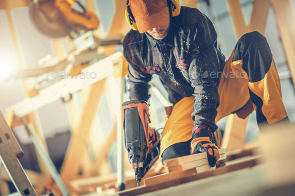 Construction Worker with Nail Gun in His Hand