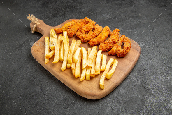 Download Top View Of Crispy And Fried Chicken Meal On Wooden Cutting Board On Dark Background Stock Photo By Kamranaydinovstudio